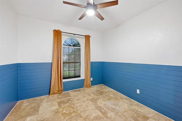 a view of a big room with wooden floor and windows