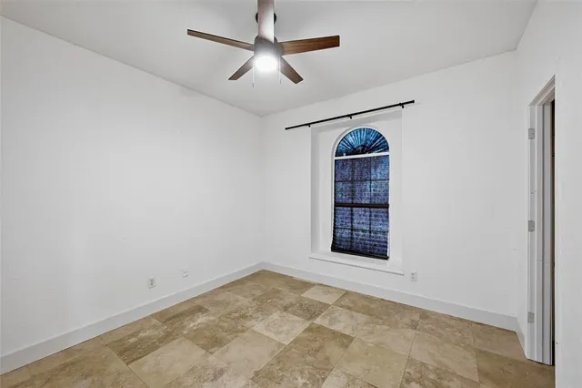 a view of a room with windows and ceiling fan