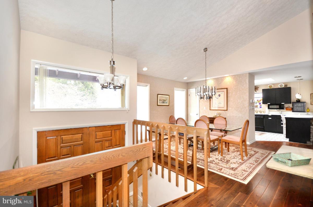 13912 Glen High Road Baldwin, MD 21013 - Photo 4 of 28 a view of a dining room and livingroom with furniture wooden floor a chandelier