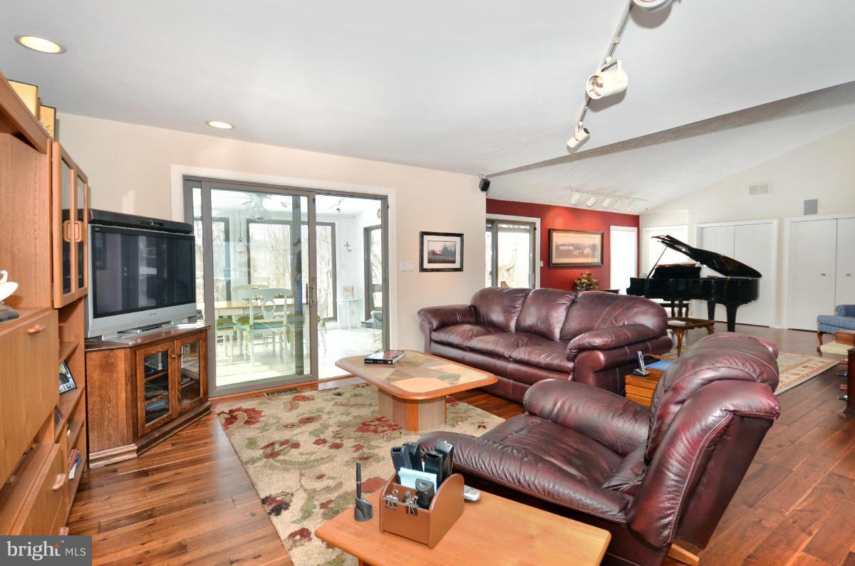 13912 Glen High Road Baldwin, MD 21013 - Photo 10 of 28 a living room with furniture fireplace and a flat screen tv