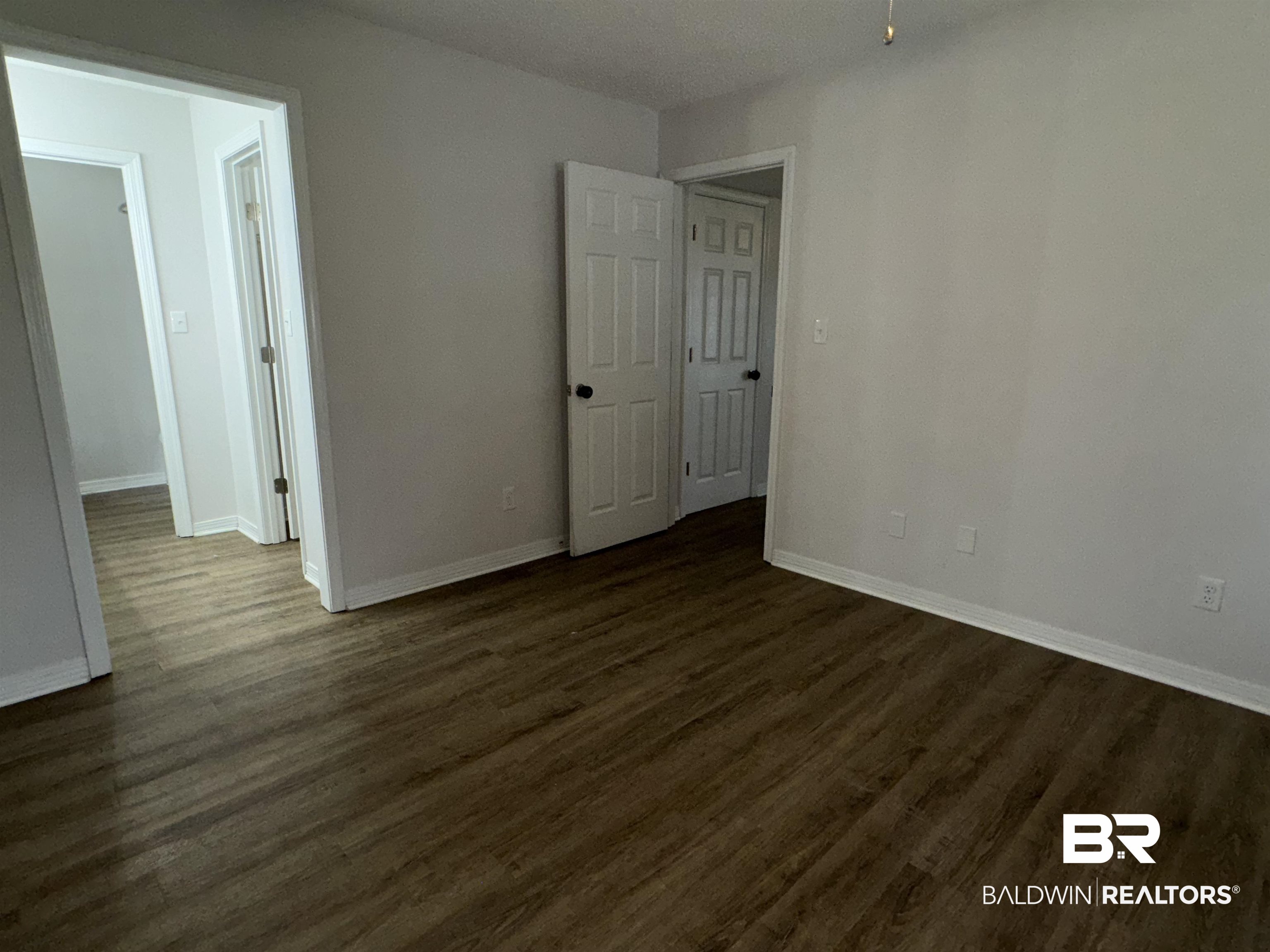 70 Plum Street Uriah, AL 36480 - Photo 16 of 36 Unfurnished room featuring ceiling fan and dark hardwood / wood-style flooring