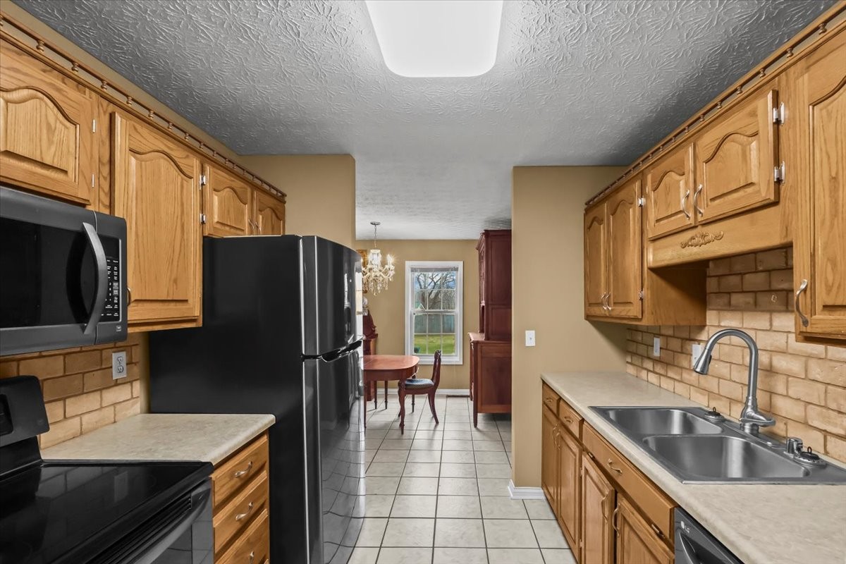 2981 Rocky Hill Road Smiths Grove, KY 42171 - Photo 11 of 31 a kitchen with stainless steel appliances granite countertop a sink stove and refrigerator