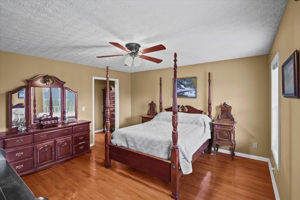 2981 Rocky Hill Road Smiths Grove, KY 42171 - Photo 14 of 31 a bedroom with a bed and a chandelier