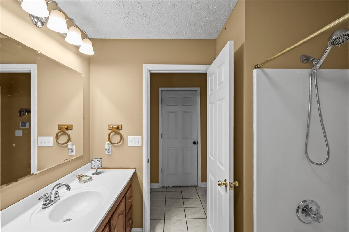 2981 Rocky Hill Road Smiths Grove, KY 42171 - Photo 16 of 31 a bathroom with a sink a vanity and a mirror