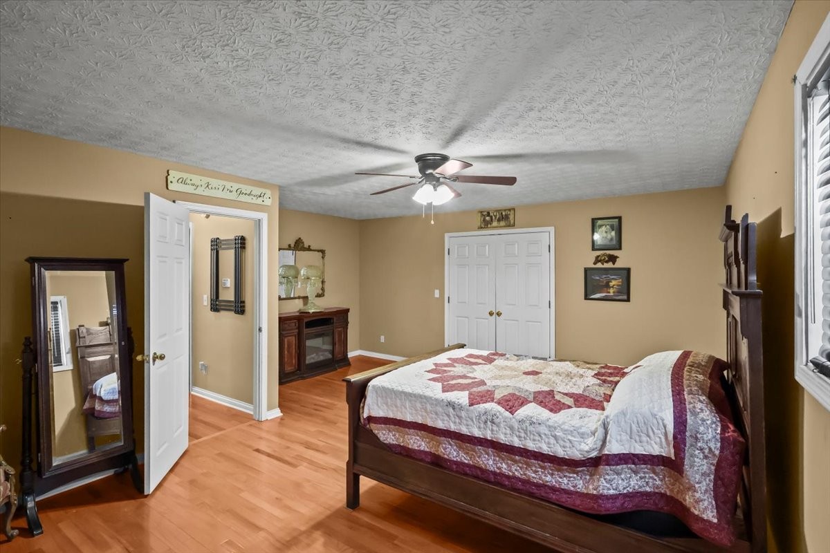2981 Rocky Hill Road Smiths Grove, KY 42171 - Photo 22 of 31 a bedroom with a large bed and a chandelier