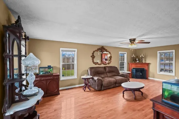 a living room with furniture a fireplace and a flat screen tv