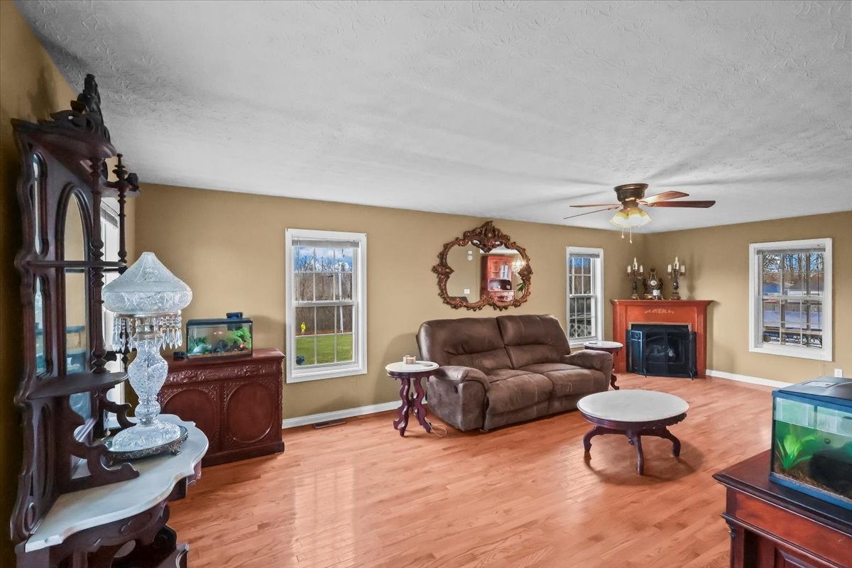 2981 Rocky Hill Road Smiths Grove, KY 42171 - Photo 5 of 31 a living room with furniture a fireplace and a flat screen tv