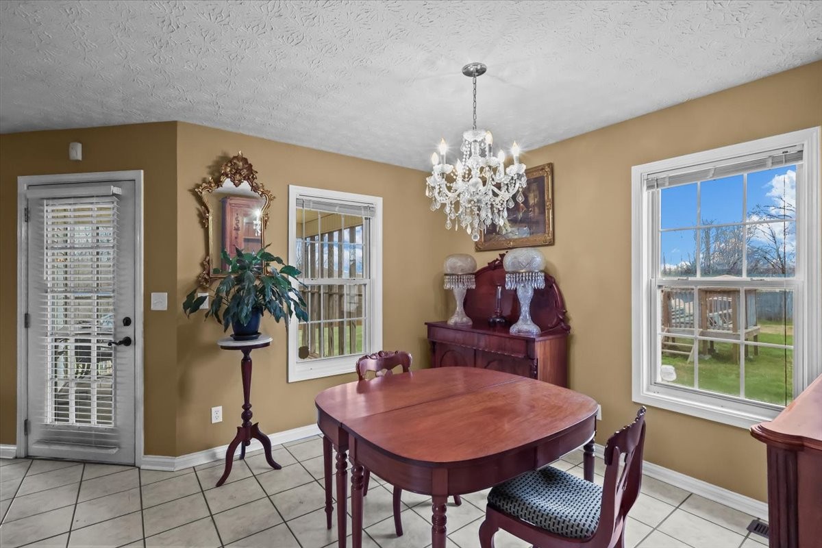 2981 Rocky Hill Road Smiths Grove, KY 42171 - Photo 9 of 31 a view of a dining room with furniture and chandelier