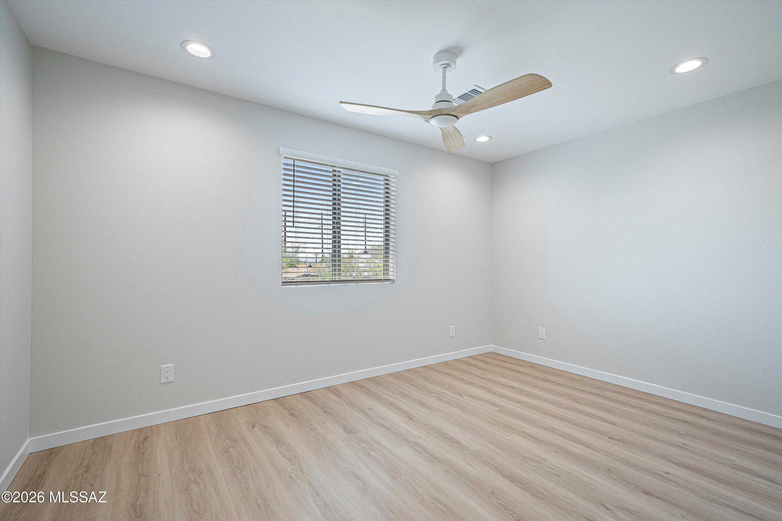 739 North Queen Avenue, Unit 2 Tucson, AZ 85705 - Photo 10 of 28 wooden floor in an empty room with a window