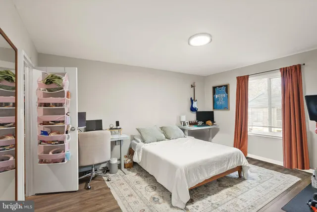 a bedroom with a large bed and a window