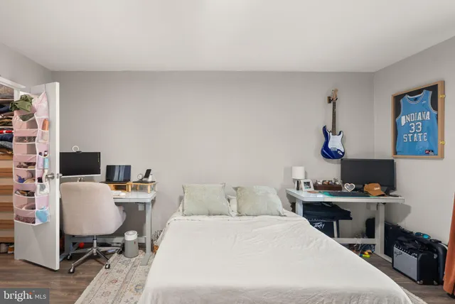 a bedroom with a bed and a desk in it