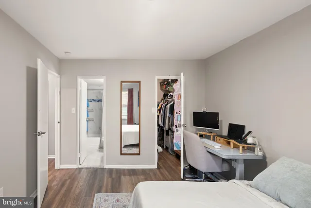 a view of a workspace with furniture and wooden floor