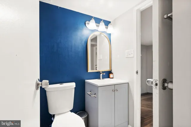a bathroom with a toilet sink and mirror