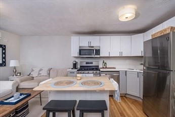 a kitchen with a dining table and chairs