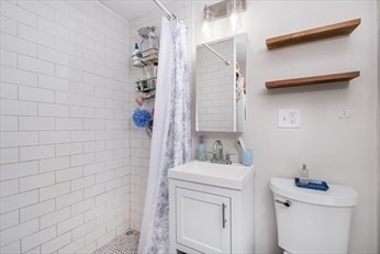 84 Emerson Street, Unit 2 Boston, MA 02127 - Photo 11 of 18 a bathroom with a sink toilet and shower