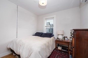 84 Emerson Street, Unit 2 Boston, MA 02127 - Photo 14 of 18 a bedroom with a bed and a table in it