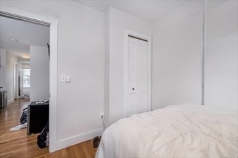 84 Emerson Street, Unit 2 Boston, MA 02127 - Photo 2 of 18 a bedroom with a bed and a mirror