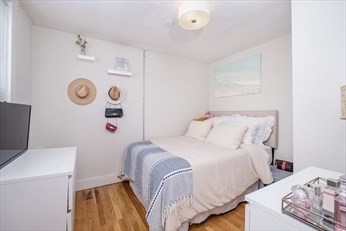 84 Emerson Street, Unit 2 Boston, MA 02127 - Photo 4 of 18 a bedroom with a bed and a window