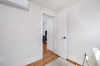 84 Emerson Street, Unit 2 Boston, MA 02127 - Photo 7 of 18 a view of a hallway with wooden floor