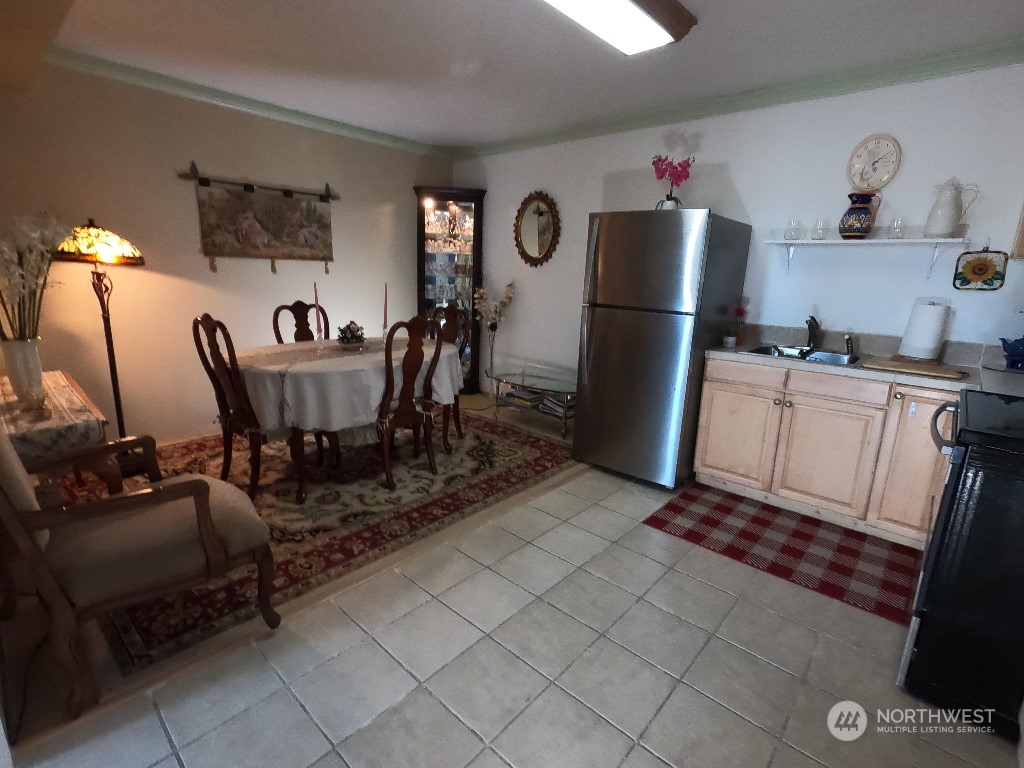 422 South 26th Street Renton, WA 98055 - Photo 17 of 24 a kitchen with stainless steel appliances granite countertop a refrigerator a stove a sink dishwasher and a dining table with wooden floor