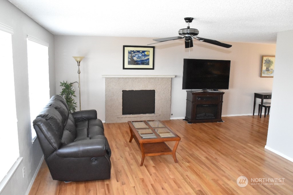 422 South 26th Street Renton, WA 98055 - Photo 2 of 24 a living room with furniture a flat screen tv and a fireplace