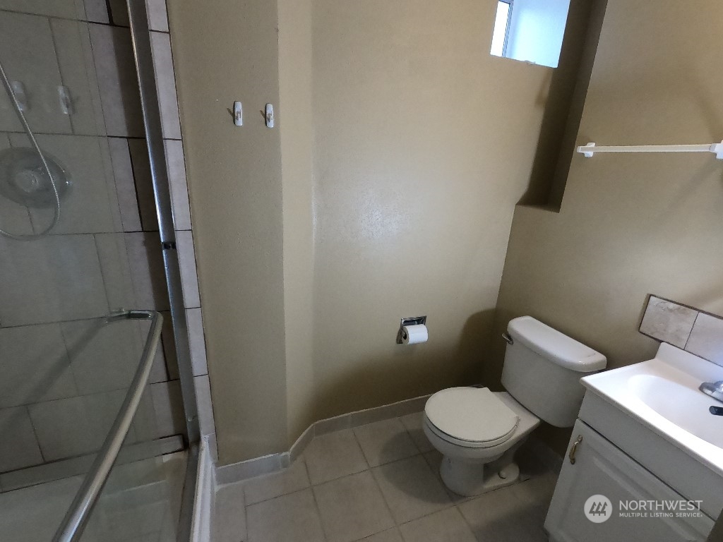 422 South 26th Street Renton, WA 98055 - Photo 22 of 24 a white toilet sitting next to a white sink and vanity