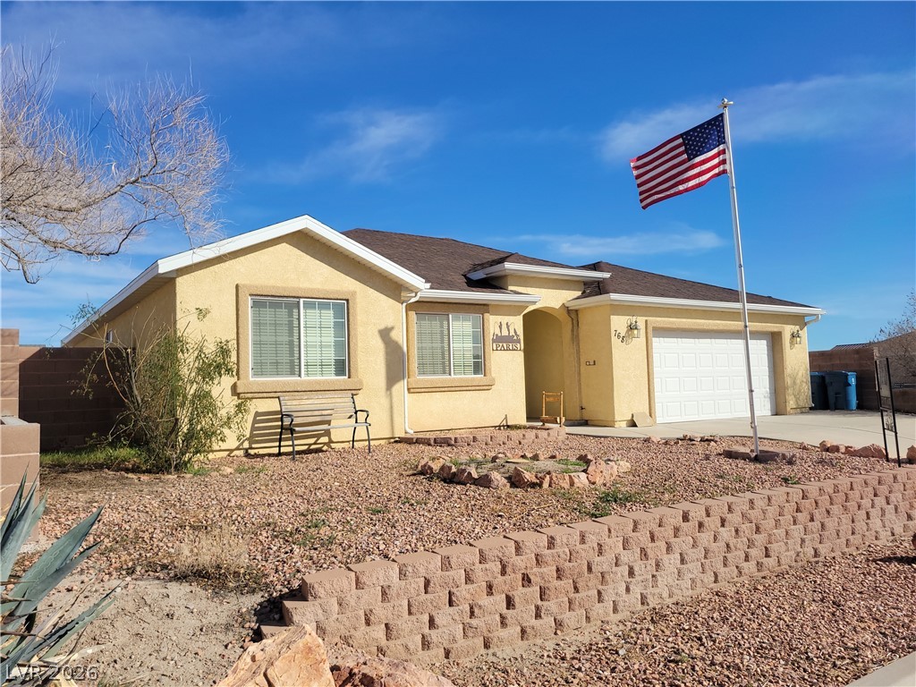 768 Weiser Ridge Street Overton, NV 89040 - Photo 1 of 37 Ranch-style house with stucco siding, an attached garage, and concrete driveway