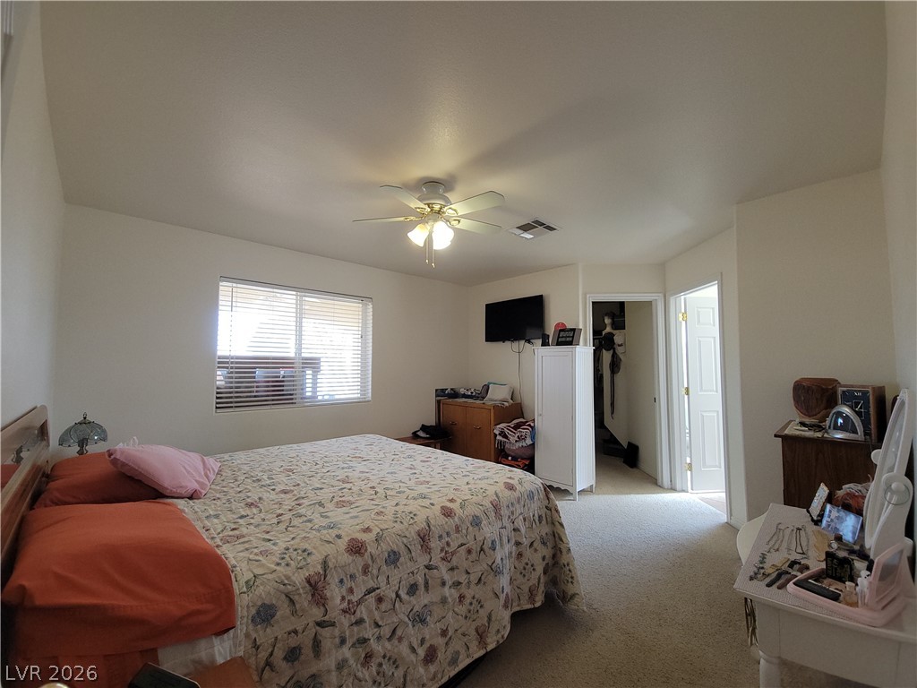 768 Weiser Ridge Street Overton, NV 89040 - Photo 13 of 37 Primary bedroom with a spacious closet, carpet, and ceiling fan