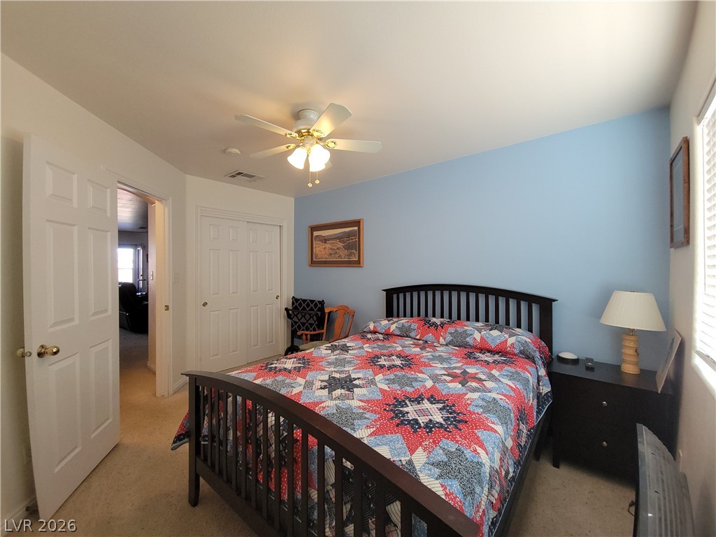 768 Weiser Ridge Street Overton, NV 89040 - Photo 19 of 37 Bedroom 2 with light carpet, a closet, and a ceiling fan