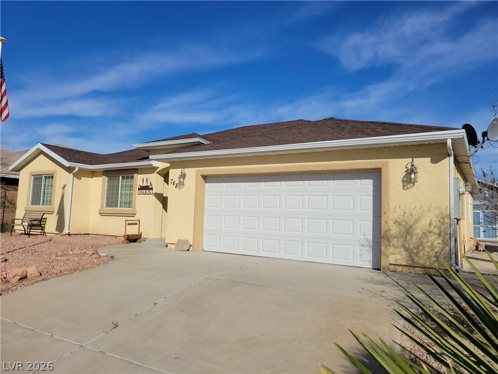 768 Weiser Ridge Street Overton, NV 89040 - Photo 2 of 37 Single story home featuring stucco siding, driveway, an attached garage, and roof with shingles