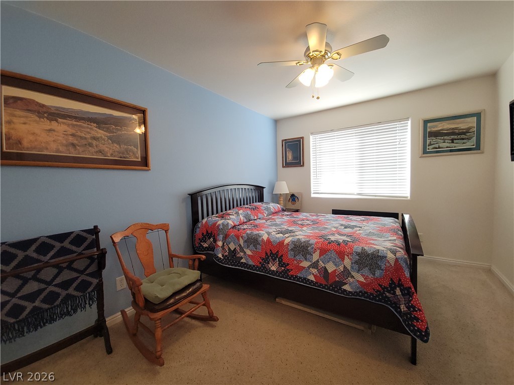 768 Weiser Ridge Street Overton, NV 89040 - Photo 20 of 37 Bedroom 2 with light carpet, a closet, and a ceiling fan