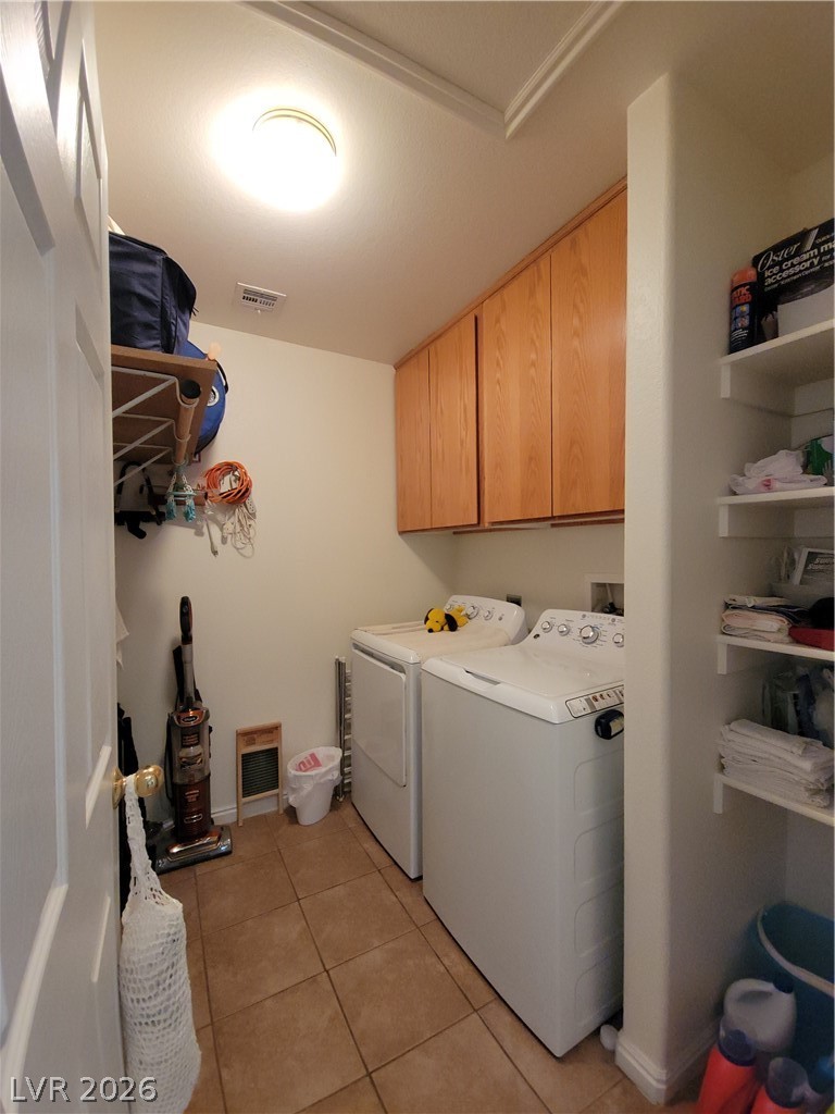 768 Weiser Ridge Street Overton, NV 89040 - Photo 24 of 37 Laundry room with cabinet space, light tile patterned floors, and washer and clothes dryer