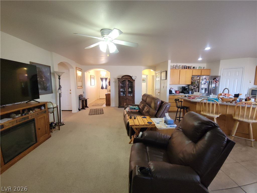 768 Weiser Ridge Street Overton, NV 89040 - Photo 9 of 37 Living area featuring arched walkways, ceiling fan, recessed lighting, and light colored carpet