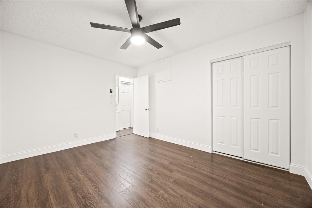 1801 Northeast 56th Street, Unit 5 Fort Lauderdale, FL 33308 - Photo 13 of 22 an empty room with wooden floor fan and windows