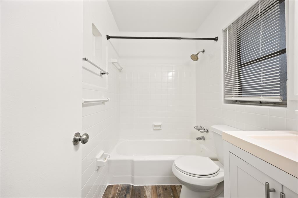 1801 Northeast 56th Street, Unit 5 Fort Lauderdale, FL 33308 - Photo 16 of 22 a bathroom with a granite countertop bathtub shower sink vanity and toilet