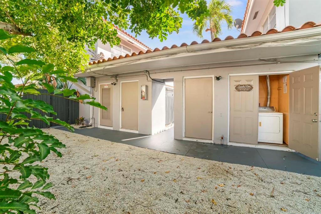 1801 Northeast 56th Street, Unit 5 Fort Lauderdale, FL 33308 - Photo 21 of 22 a front view of a house with a yard and garage