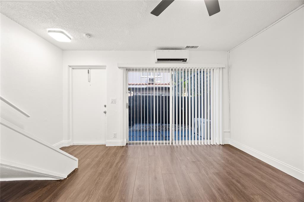 1801 Northeast 56th Street, Unit 5 Fort Lauderdale, FL 33308 - Photo 3 of 22 an empty room with wooden floor