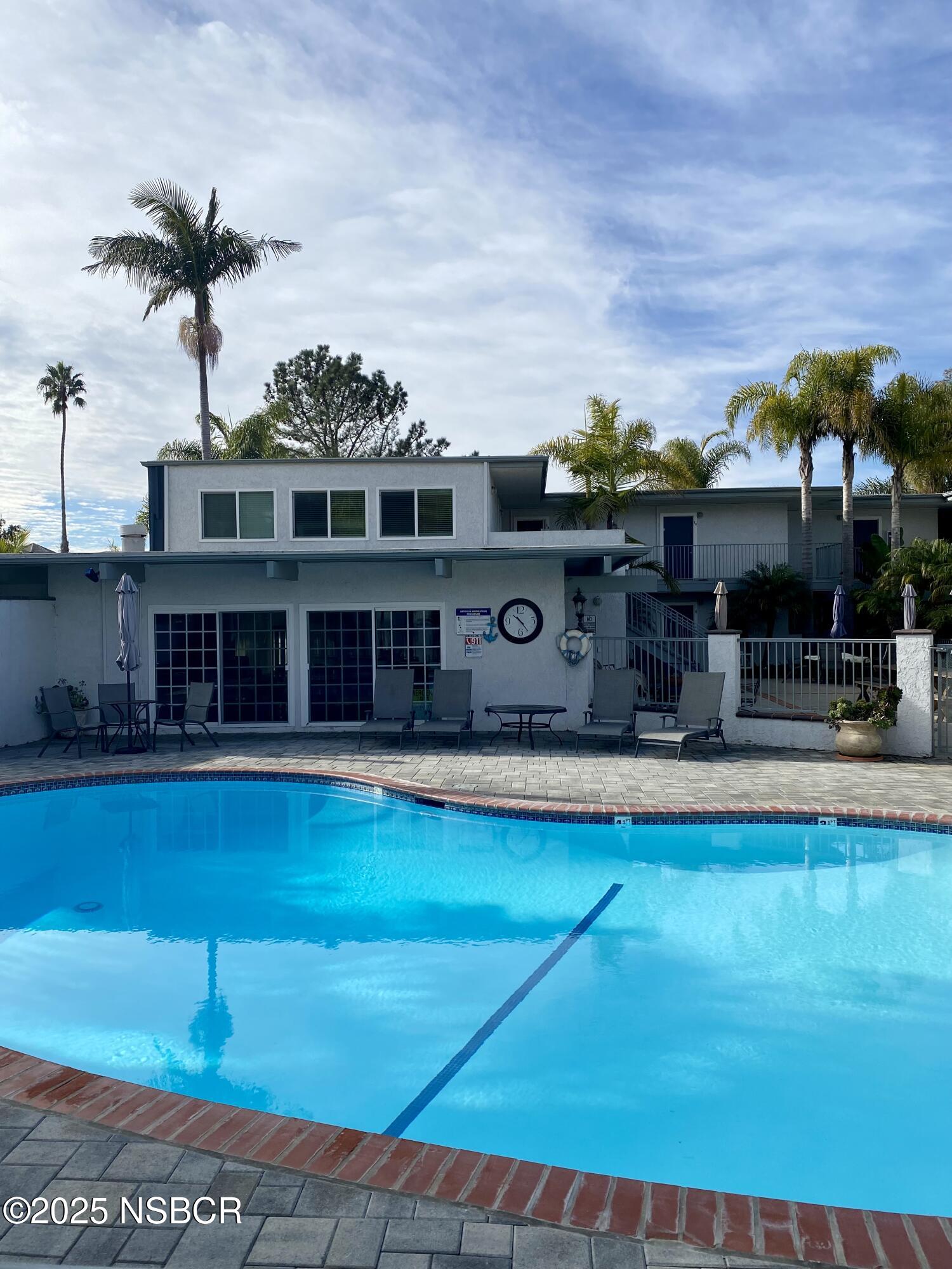 4880 Sandyland Road, Unit 11 Carpinteria, CA 93013 - Photo 12 of 28 a view of a swimming pool with a patio