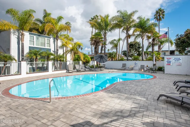 a swimming pool with outdoor seating and yard