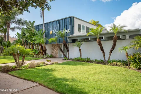 a view of a house with a yard and plants