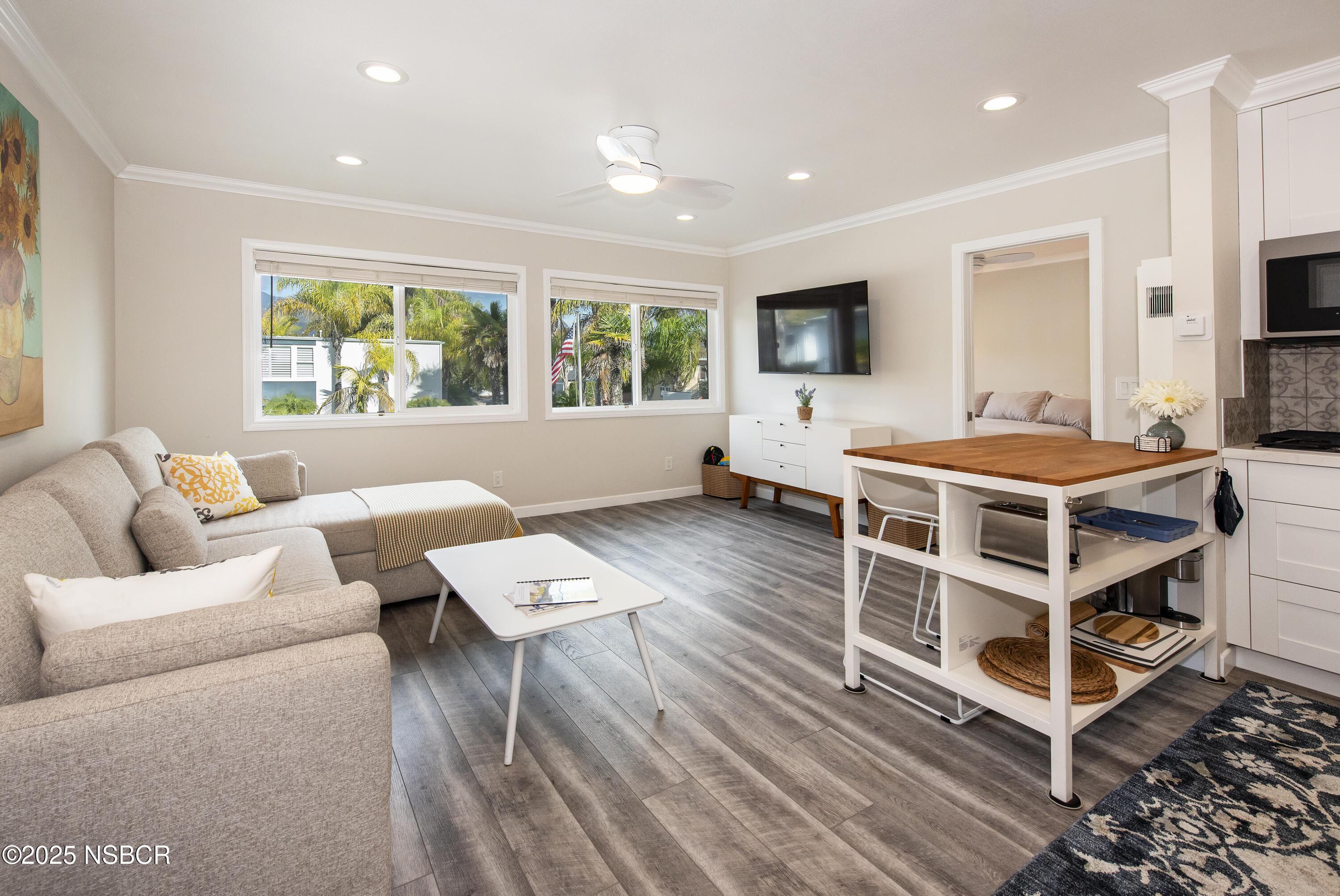 4880 Sandyland Road, Unit 11 Carpinteria, CA 93013 - Photo 2 of 28 a living room with furniture and a flat screen tv
