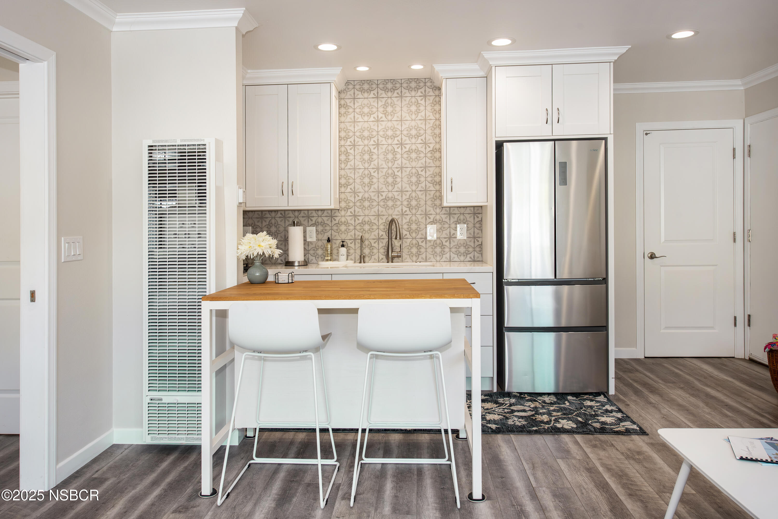 4880 Sandyland Road, Unit 11 Carpinteria, CA 93013 - Photo 6 of 28 a view of kitchen with stainless steel appliances refrigerator wooden floor dining table and chairs