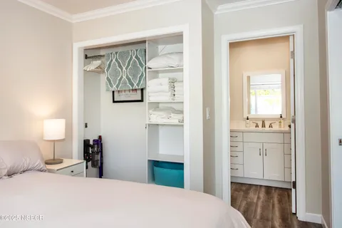 a bedroom with a bed and a mirror