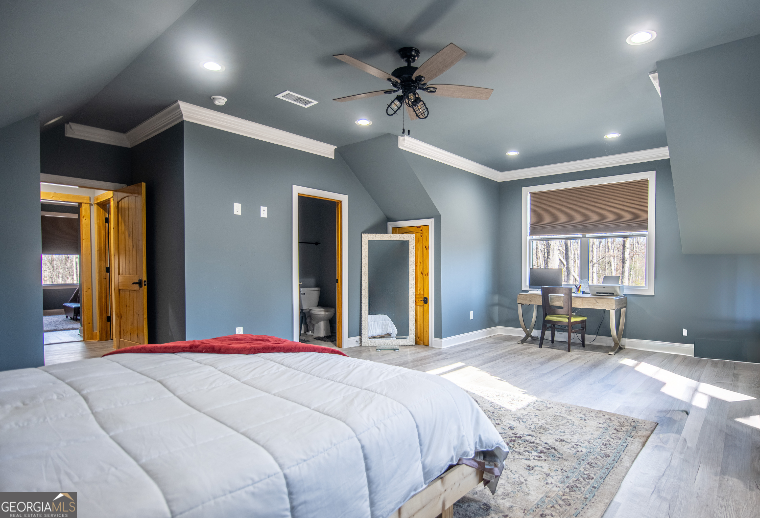 203 Teasley Lane Hartwell, GA 30643 - Photo 23 of 32 a bedroom with a bed and a chandelier