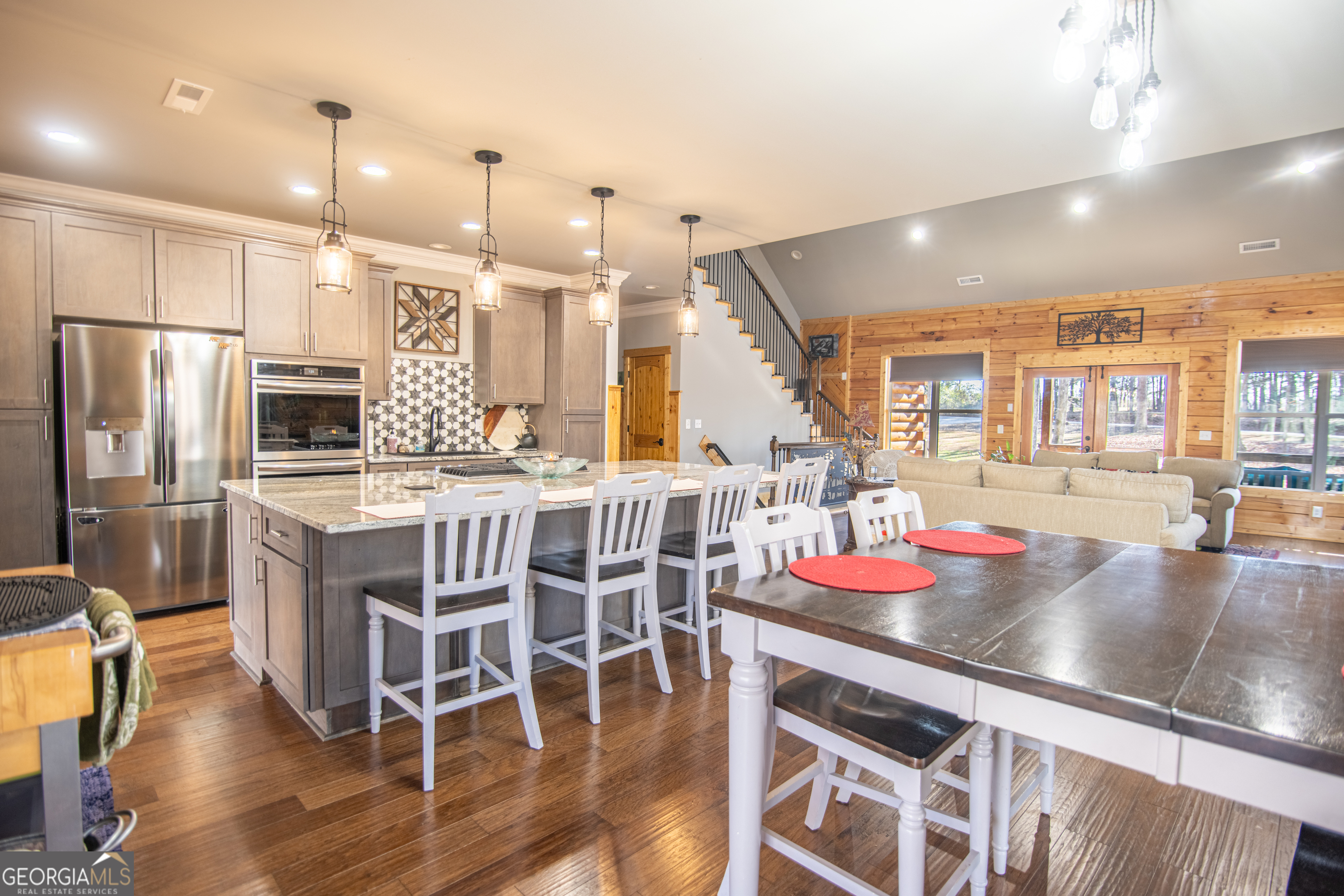 203 Teasley Lane Hartwell, GA 30643 - Photo 7 of 32 a kitchen with stainless steel appliances kitchen island granite countertop a table chairs stove and refrigerator