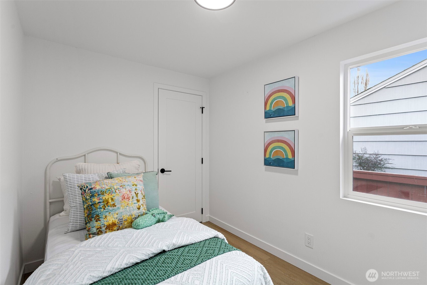 8608 16th Avenue Southwest Seattle, WA 98106 - Photo 14 of 26 a bedroom with a bed and a window