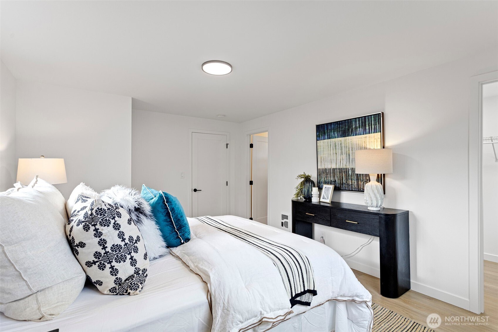 8608 16th Avenue Southwest Seattle, WA 98106 - Photo 16 of 26 a bedroom with a bed and a table in it