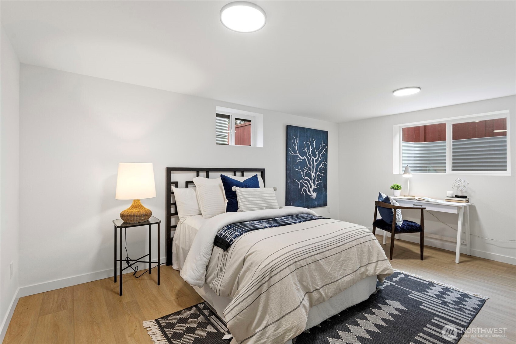 8608 16th Avenue Southwest Seattle, WA 98106 - Photo 20 of 26 a bedroom with a bed and a table in it
