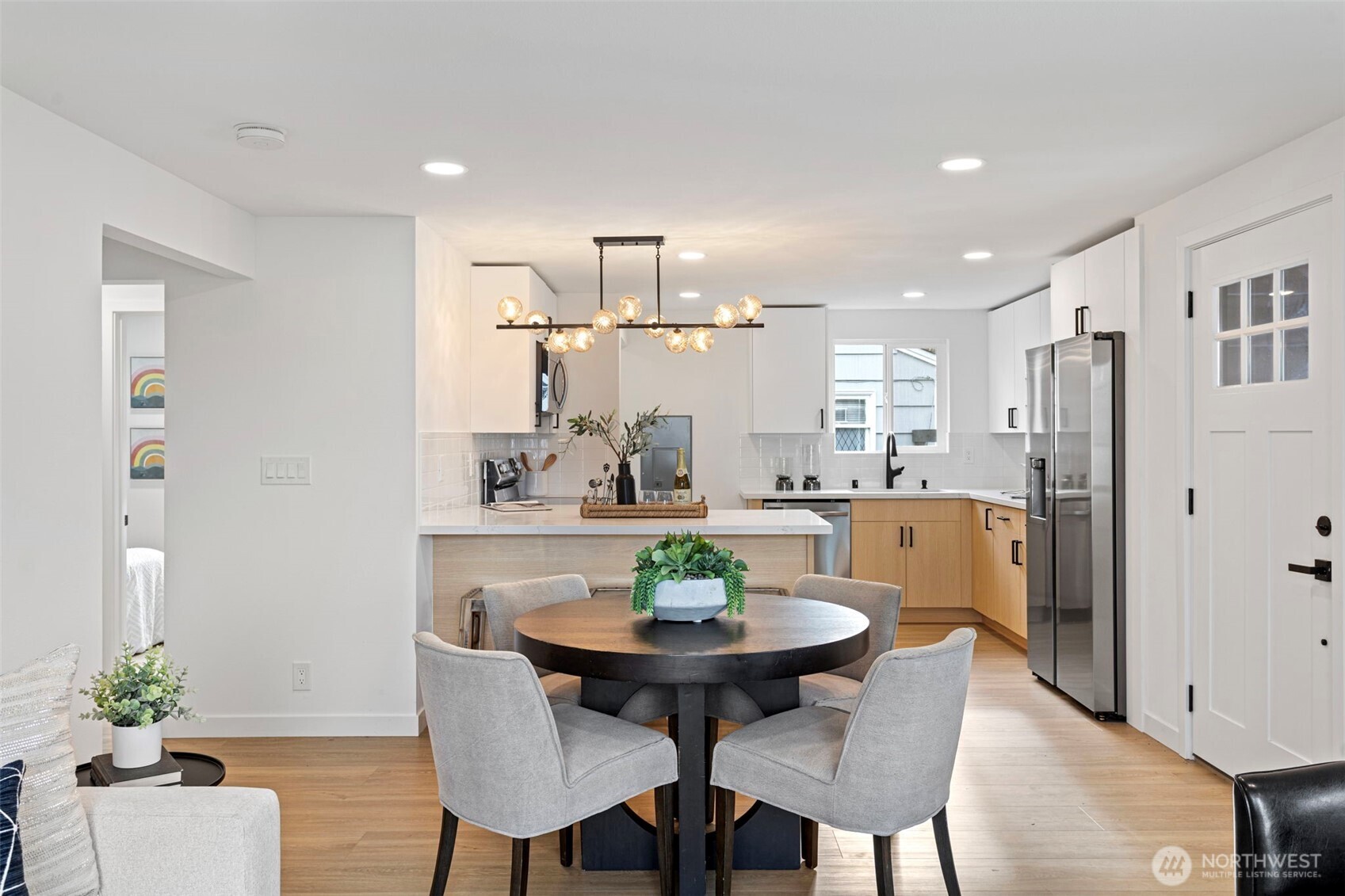 8608 16th Avenue Southwest Seattle, WA 98106 - Photo 4 of 26 a view of a dining room with furniture and wooden floor