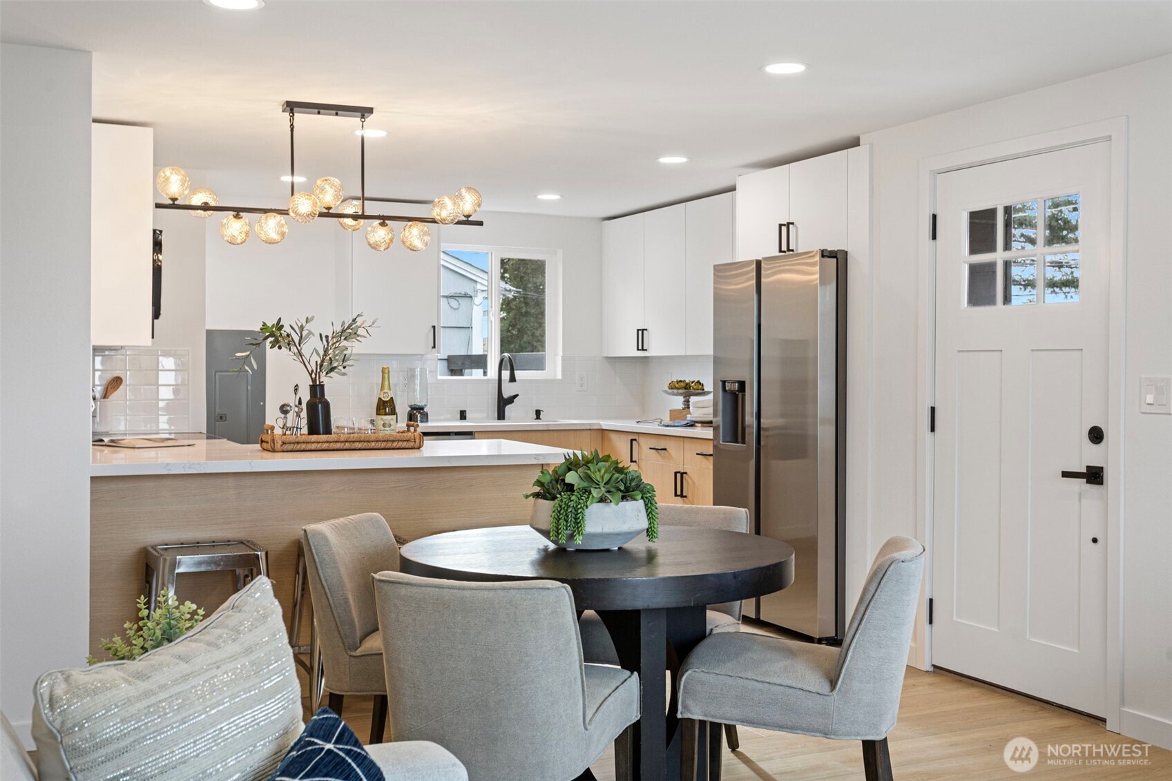 8608 16th Avenue Southwest Seattle, WA 98106 - Photo 6 of 26 a kitchen with refrigerator cabinets dining table and chairs